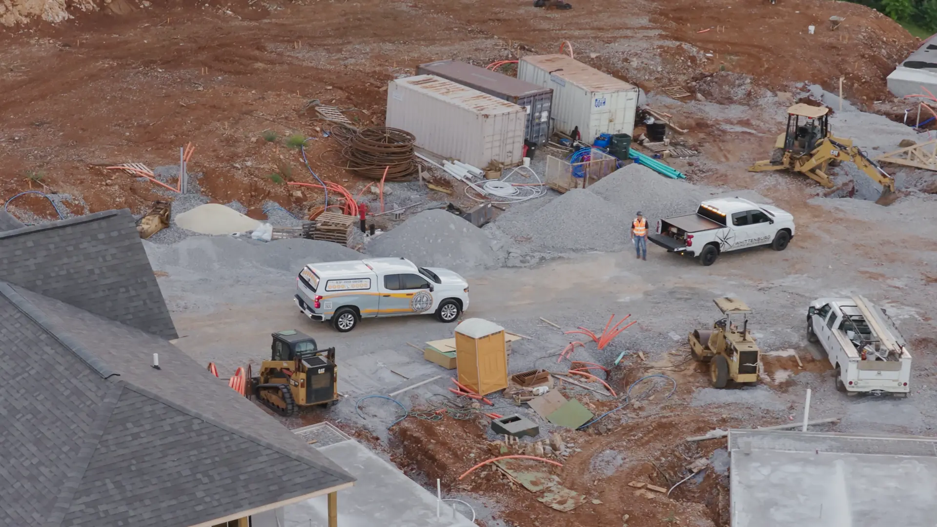 Graded construction site with storage containers before a new building project begins