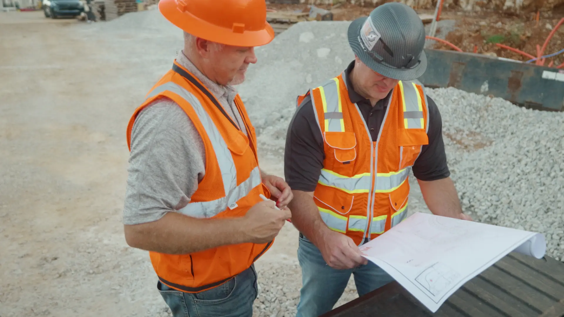 Two Utility Locators technicians reviewing project plans together